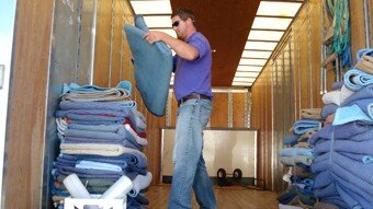 Advance Movers in Greenville NC loading moving blankets in the back of a truck.