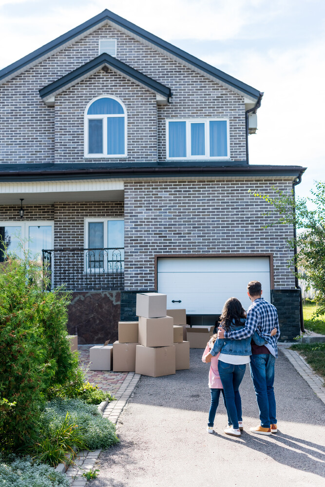 A family moving into their new home after having been moved by Advance Moving, the premier movers in Greenville NC.